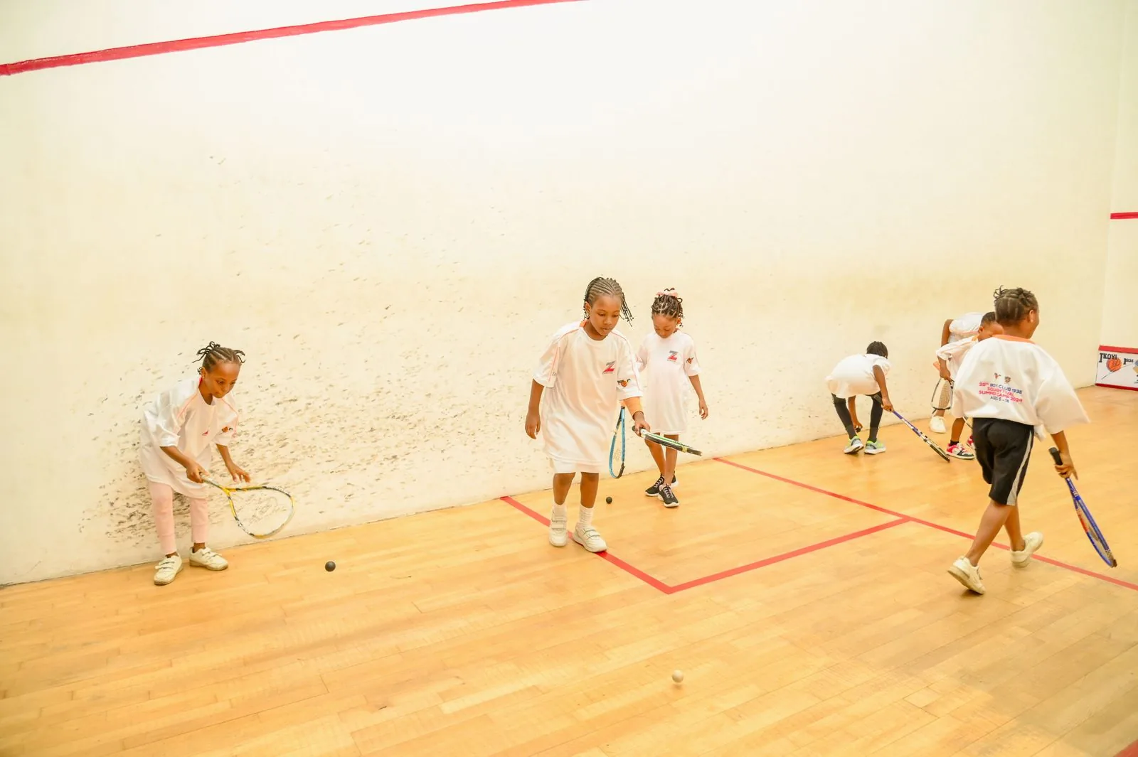Young girls practising squash together