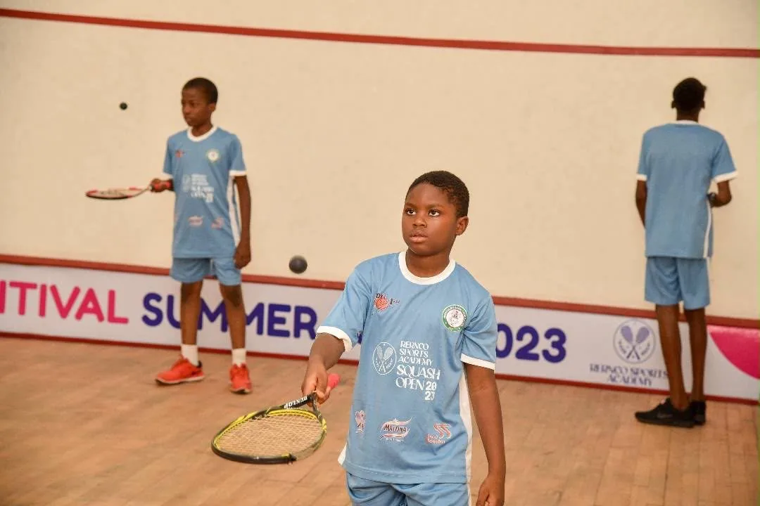 Young athletes mid-match on the squash court