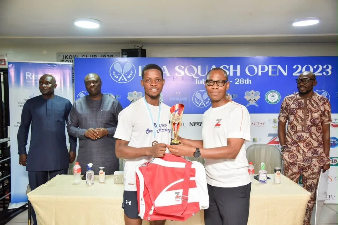 A young athlete receiving a trophy at a Sports Bridge tournament